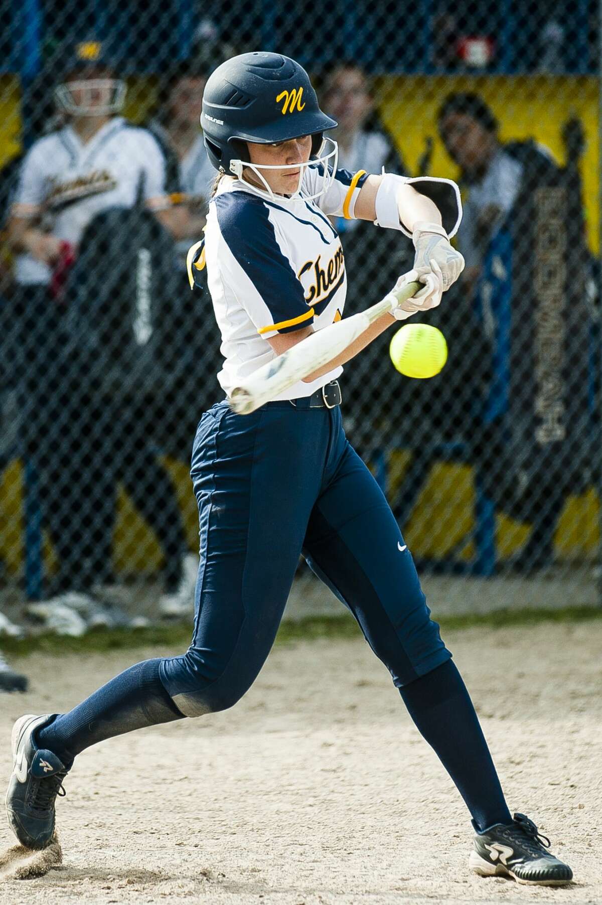 Midland's Maggie Gomola swings on a pitch during a game against Lapeer on Monday, April 22, 2019 at Midland High School. (Katy Kildee/kkildee@mdn.net)
