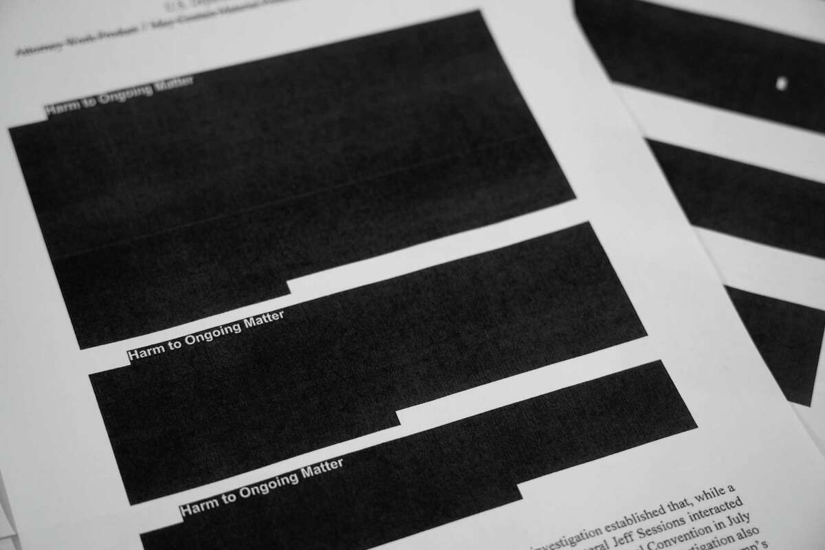 Special counsel Robert Mueller's report, with redactions, as released on Thursday, April 18, 2019, is photographed in Washington. (AP Photo/Jon Elswick)