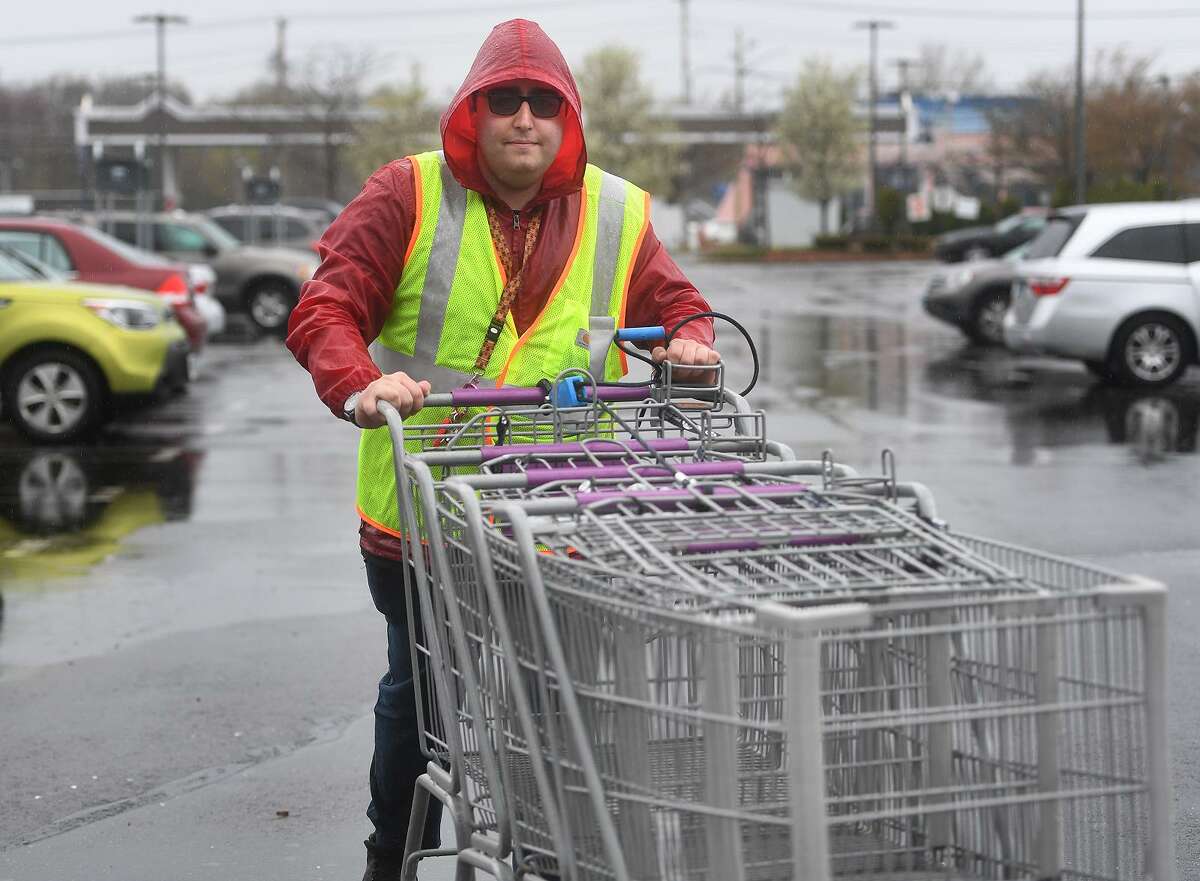 Stop & Shop employee Justin Klein, of Milford, retrieves shopping carts outside the store at 855 Bridgeport Avenue in Milford, Conn. on Monday, April 22, 2019. An 11 day strike by employees ended at the grocery store chain after a tentative agreement was reached on Sunday.