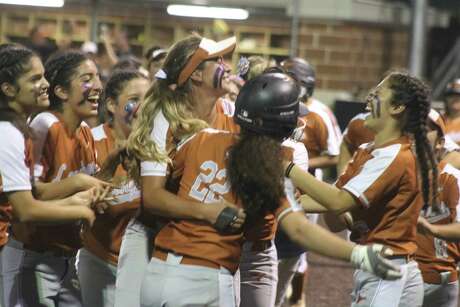 More Dobie players mob Karlie Barba (22) after her dramatic game-winning hit Monday night at Humble High School.