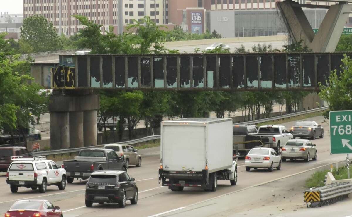 The famed "Be Someone" bridge is seen covered in black paint Tuesday, April 23, 2019.