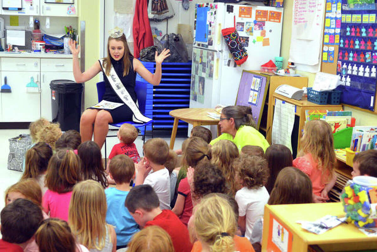 Preschoolers listen as Missy Huddleston, Miss Madison County Fair 2018, reads a story on Monday afternoon at Early Explorations Too in Glen Carbon.