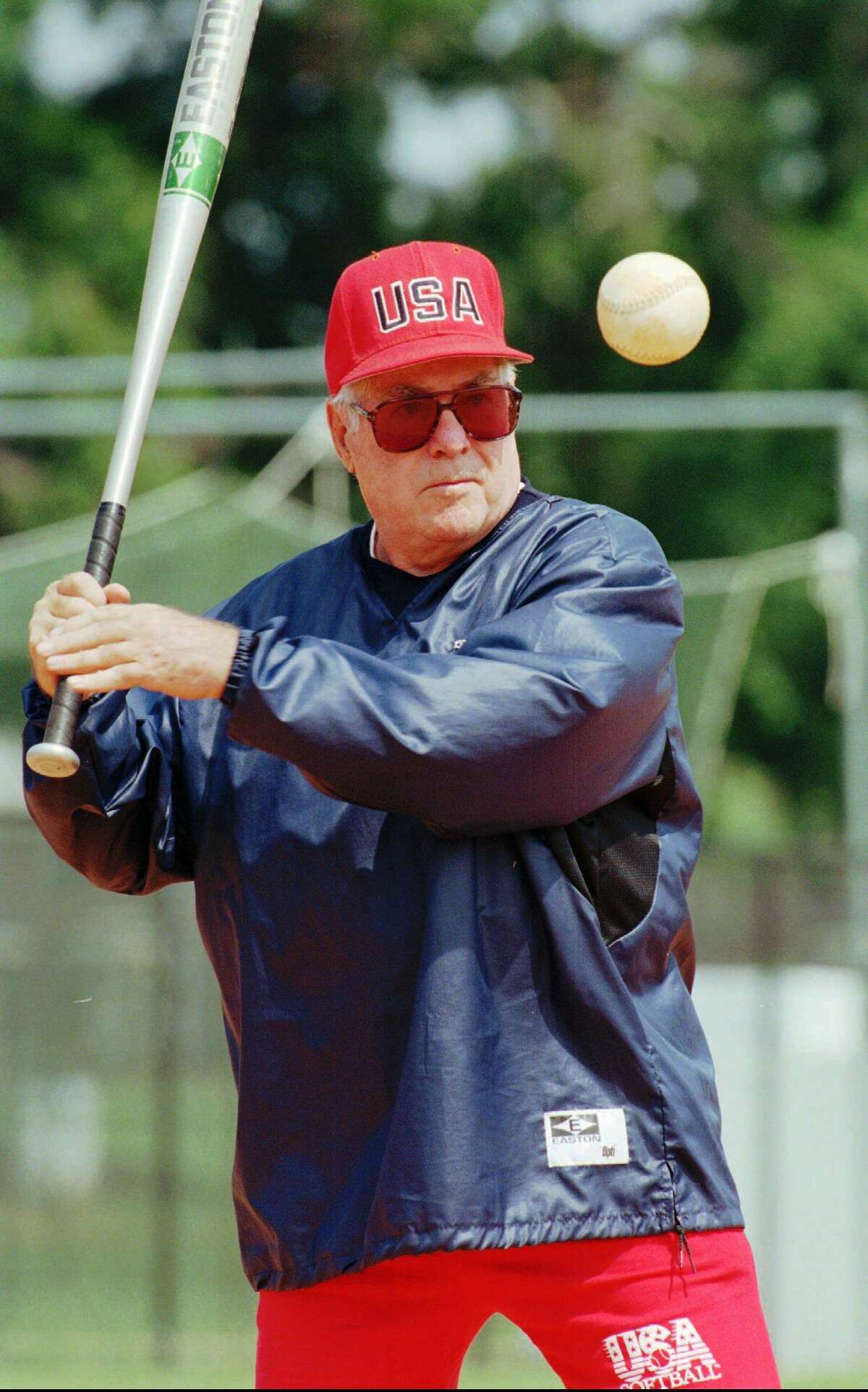 USA Olympic women's softball team head coach Ralph Raymond hits to the team during practice at the South Commons softball complex in Columbus, Ga., June 4, 1996. As coach of the USA women's national teams, Raymond has won five gold medals in international Softball Federation play, including three consecutive titles, 1986, 1990, 1994, with a combined record of 72-1.