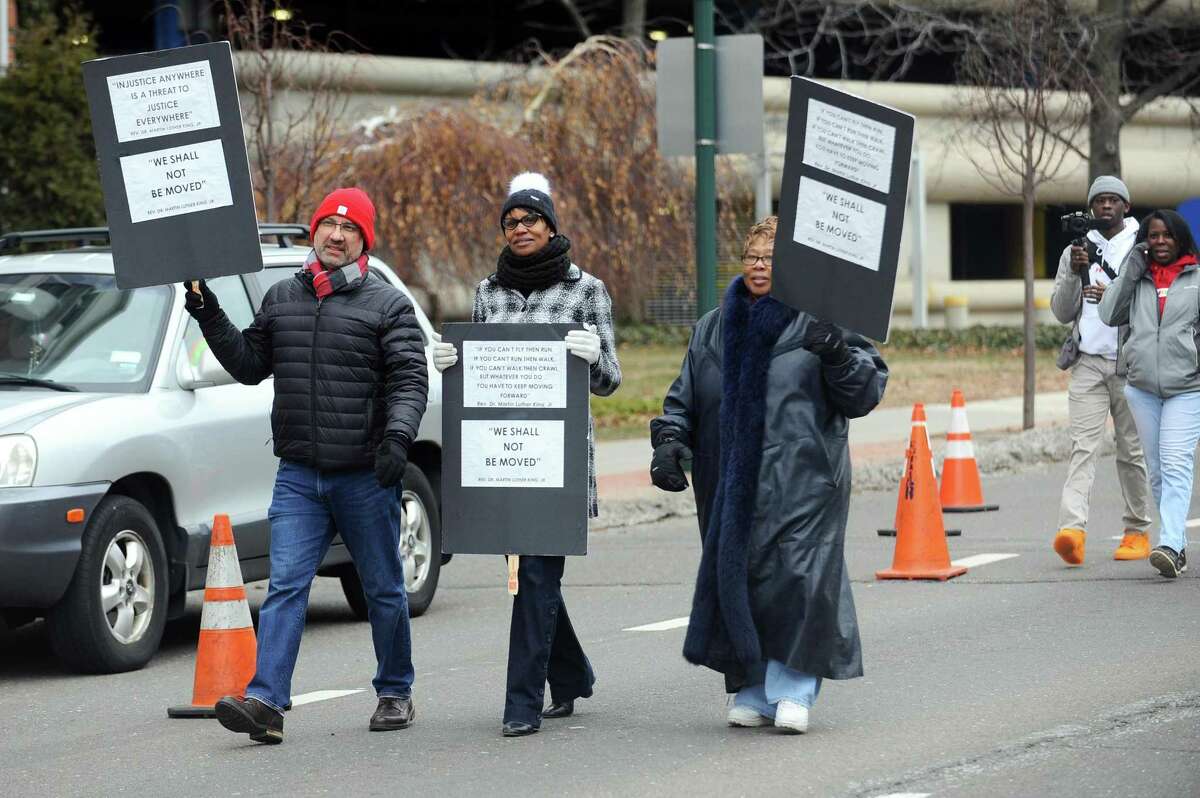 Stamford Assistant Superintendent Dr. Tamu Lucero, center, walks in the annual Martin Luther King Jr. Day march in Stamford, Conn. on Monday, Jan. 15, 2018. The school board is expected to vote Tuesday night to name Lucero as the new leader of the school district.