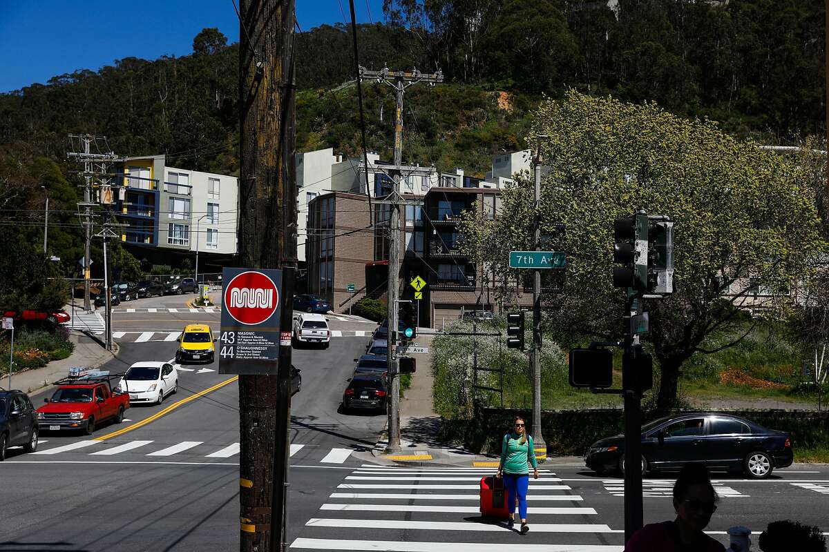 A woman crosses Warren Drive and 7th Street in San Francisco, California, on Tuesday, April 23, 2019.