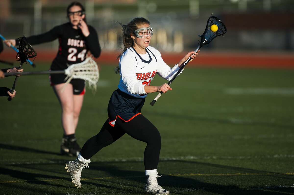 Midland's Morgan Goudie carries the ball toward the goal during a game against Grand Blanc on Tuesday, April 23, 2019 at Midland Community Stadium. (Katy Kildee/kkildee@mdn.net)