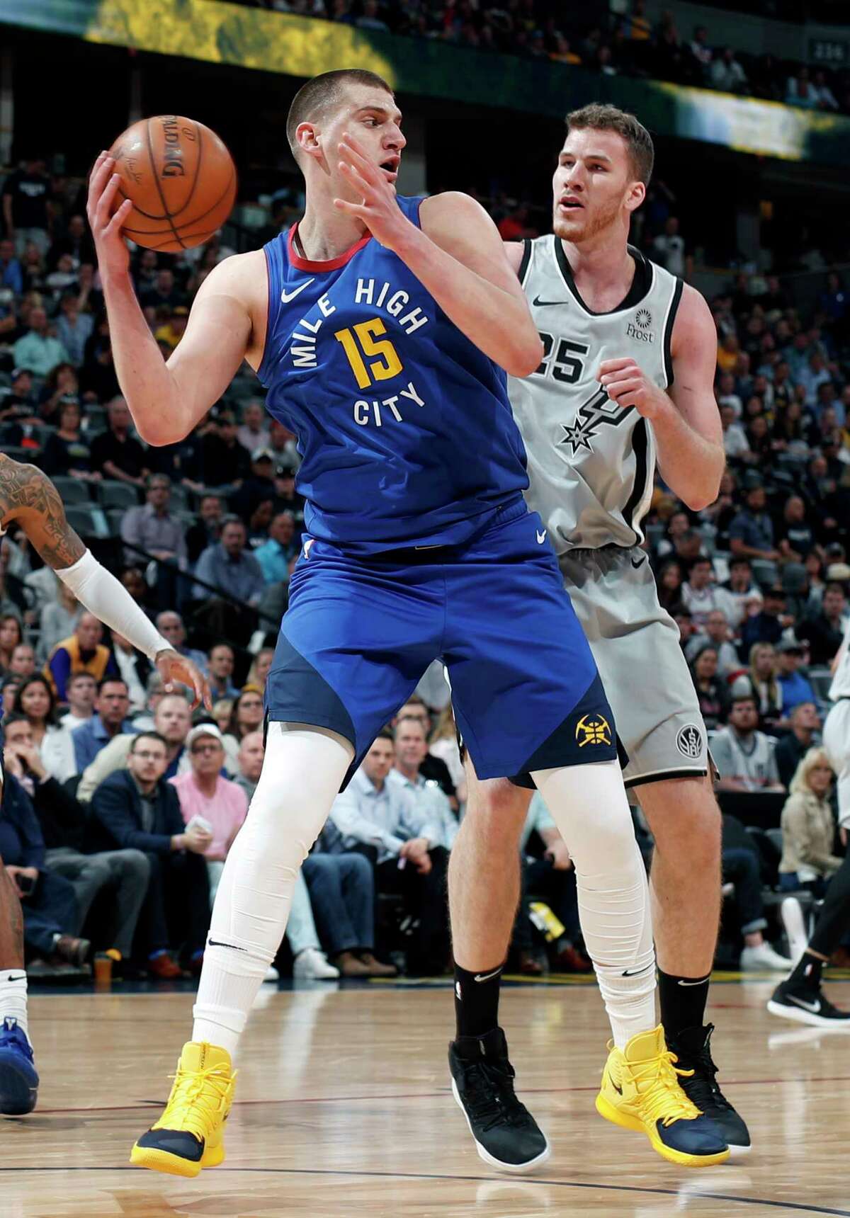 Denver Nuggets center Nikola Jokic (15) is pressured by San Antonio Spurs center Jakob Poeltl (25) in the first half of Game 5 of an NBA basketball first-round playoff series Tuesday, April 23, 2019, in Denver. (AP Photo/David Zalubowski)