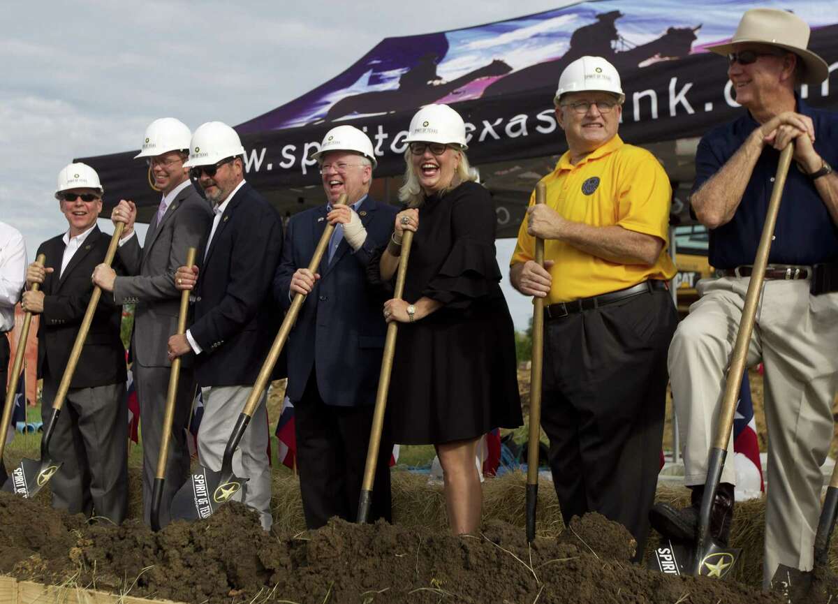 Spirit of Texas Bank CEO Dean Bass, center, shares a a laugh beside Montgomery Mayor Sara Countryman during a groundbreaking ceremony for Spirit of Texas Bank's 16th location at Texas 105 and Lone Star Parkway on Wednesday, Sept. 5, 2018, in Montgomery.