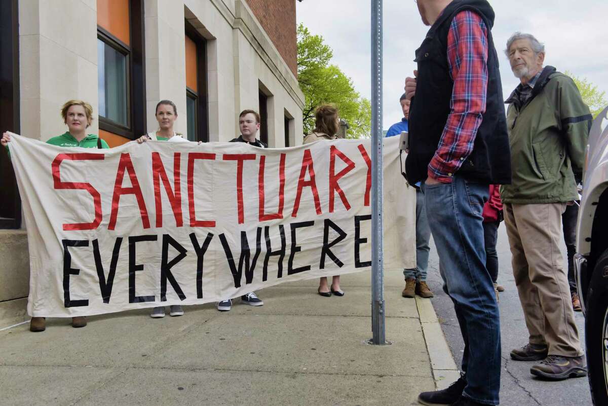 Members of the Troy Sanctuary Campaign whoare in favor of legislation that would provide illegal immigrants with driver's license take part in a rally outside the Rensselaer County DMV office on Wednesday, April 24, 2019, in Troy, N.Y. (Paul Buckowski/Times Union)