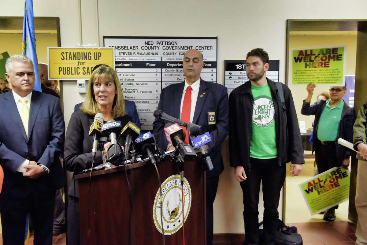 Senator Daphne Jordan along with other elected officials voice their opposition to legislation that would provide illegal immigrants with driver's license during a press event at the Rensselaer County DMV office on Wednesday, April 24, 2019, in Troy, N.Y. A group of people in favor of the legislation, on right in photo, showed up to protest at the press event. (Paul Buckowski/Times Union)