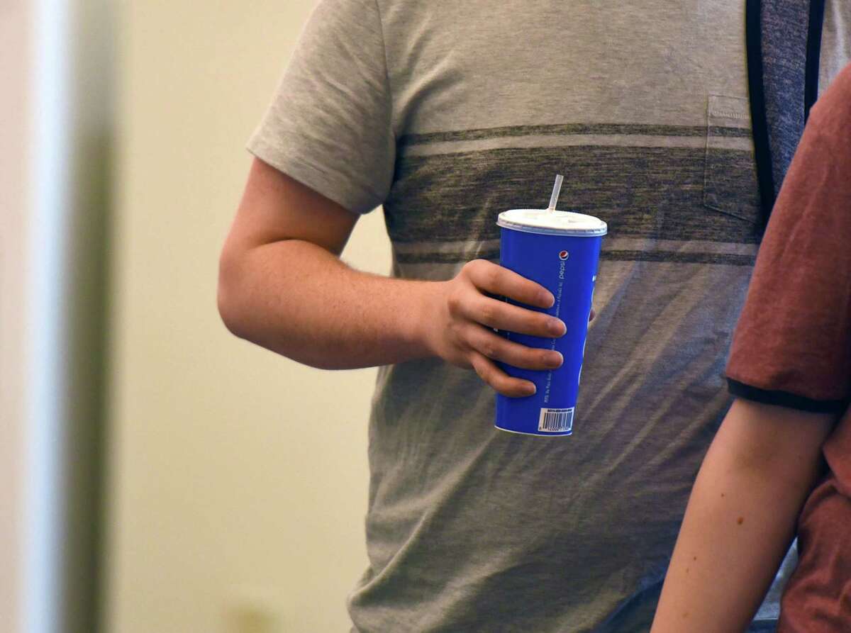 A student carries a drink with a plastic straw on Wednesday, April 24, 2019 at UAlbany's Student Center dining hall in Albany, NY. (Phoebe Sheehan/Times Union)