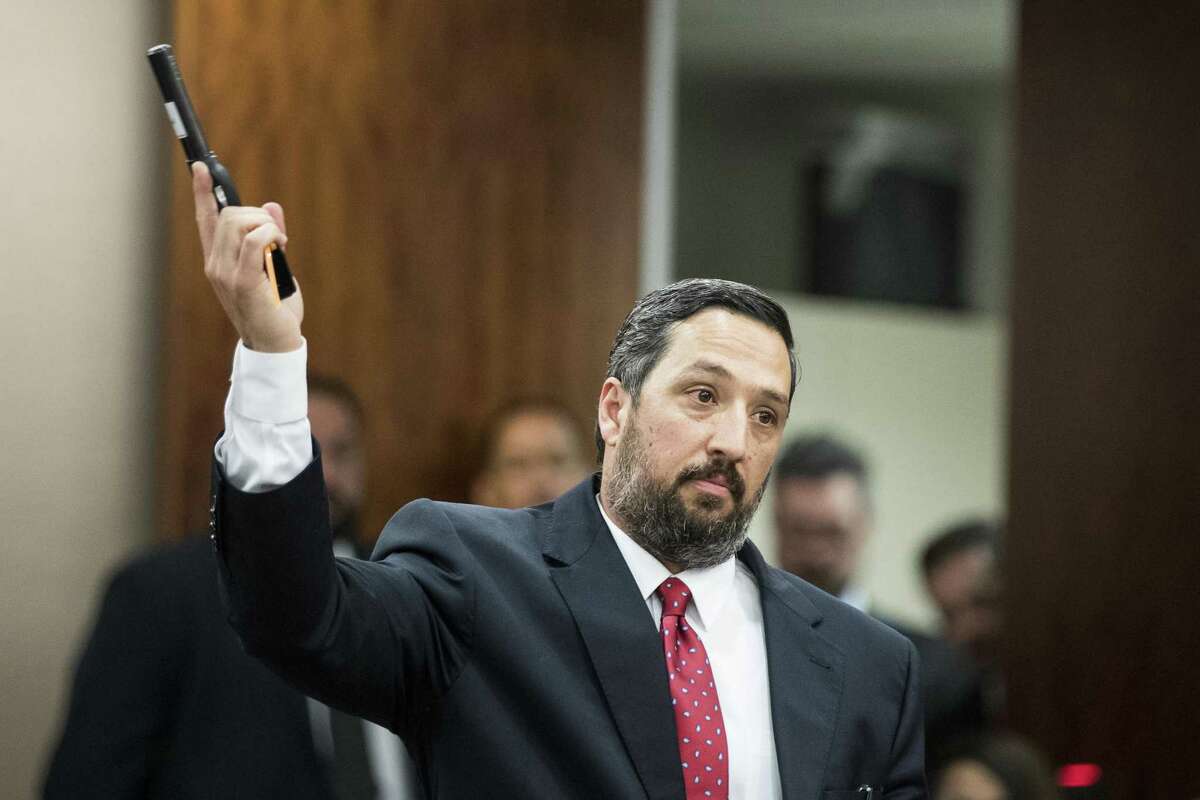 Defense attorney Rick DeToto holds up a handgun as he gives his closing arguments in the trail of Antonio Armstrong, Jr., on Wednesday, April 24, 2019, in Houston. He's accused of killing his parents, Dawn Armstrong and ex-NFL player Antonio Armstrong, Sr., on July 29, 2016 at their Bellaire-area home.