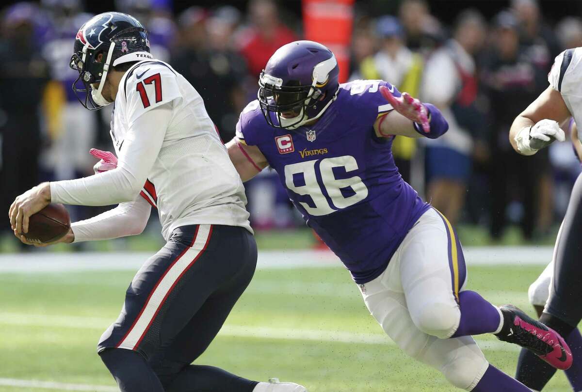 Minnesota Vikings defensive end Brian Robison (96) hits Houston Texans quarterback Brock Osweiler (17) on a pass play during the fourth quarter of an NFL football game at U.S. Bank Stadium on Sunday, Oct. 9, 2016, in Minneapolis. Osweiler escaped the sack and threw the ball away for an incomplete pass.