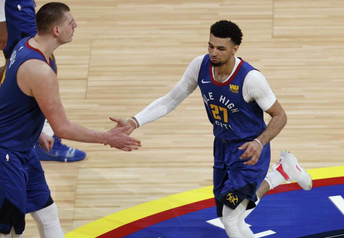 Denver Nuggets center Nikola Jokic, left, congratulates guard Jamal Murray after he scored a basket against the San Antonio Spurs in the second half of Game 5 of an NBA basketball first-round playoff series Tuesday, April 23, 2019, in Denver. The Nuggets won 108-90.