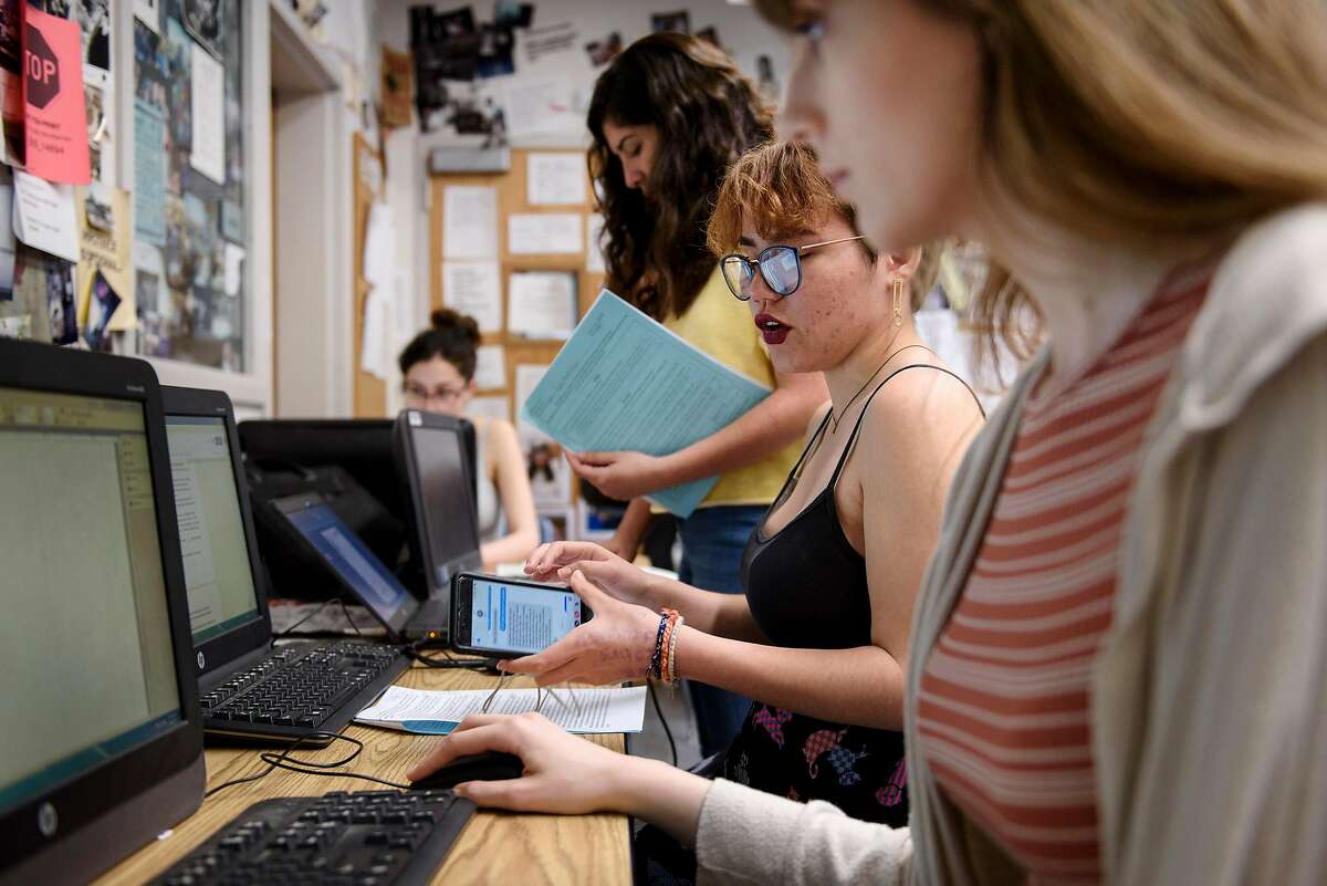 Journalism students Gabriella Backus, center, and Bailey Kirkeby design the layout of the Bruin Voice school paper at Bear Creek High School in Stockton, Calif, on Wednesday, April 24, 2019. The Stockton school district is threatening to fire Kathi Duffel, faculty adviser for the Bruin Voice student newspaper, if she doesn't show them a certain story in advance, violating the papers First Amendment freedom of the press rights.