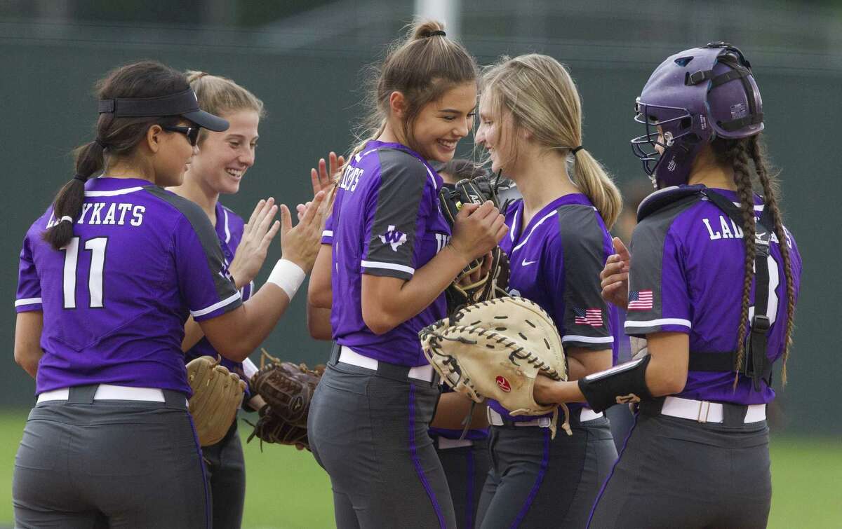 Willis players give each other high-fives before the start of Game 1 of a Region III-5A bi-district softball playoff match, Wednesday, April 24, 2019, in Willis.