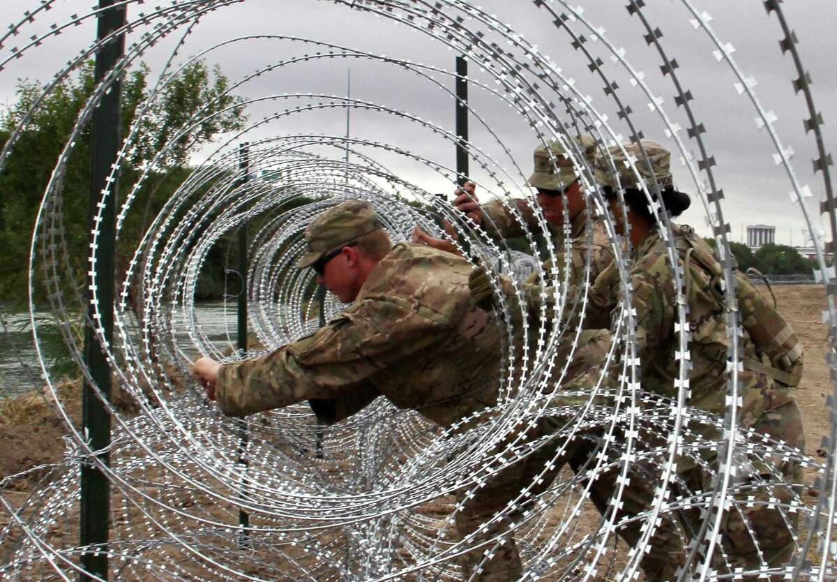 In this file photo taken on November 18, 2018, soldiers from the Kentucky-based 19th Engineer Battalion install barbed wire fences on the banks of the Rio Grande in Laredo, Texas.