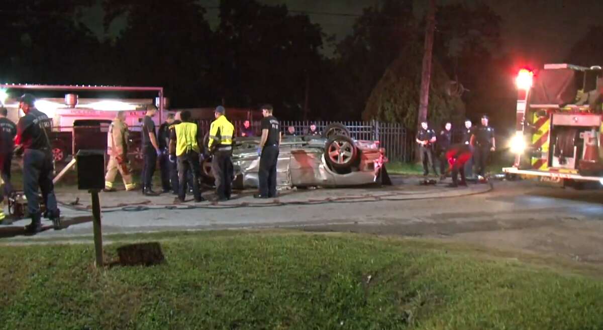 Houston police and firefighters respond to a single-vehicle crash Thursday, April 25, that killed two people in Northeast Houston. Police said the driver fell asleep at the wheel.
