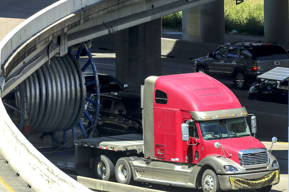 Large truck carrying spool stuck under bridge on Southwest