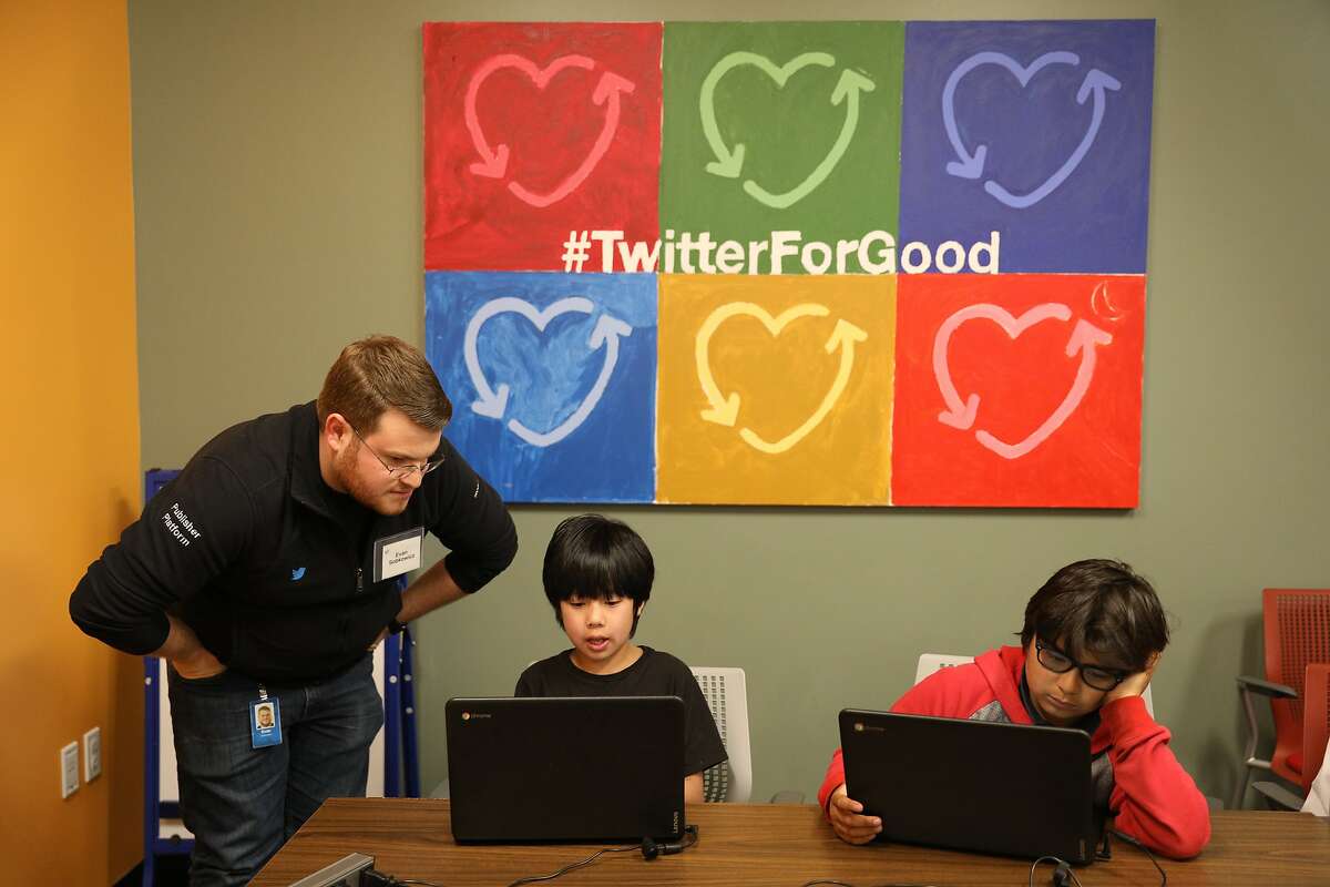 Evan Sobkowicz (l to r), Twitter software engineer, works with Jeffrey, 9, and Luca, 10, during an interactive coding workshop at Neighbor Nest on Thursday, March 21, 2019 in San Francisco, Calif.