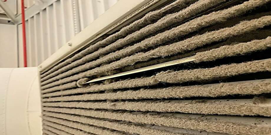 Mold buildup on an air vent at Westhill High School in Stamford. One small strip is cleaned off to show the extent of the infestation. Photo: Contributed Photo/Stamford Public Schools / Contributed Photo/Stamford Public Schools / Stamford Advocate Contributed