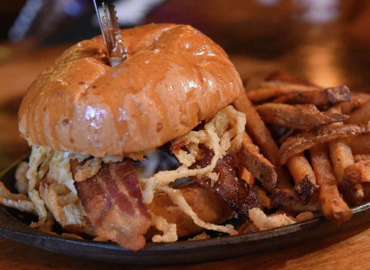 The cowboy burger - half-pound burger topped with sliced cheddar cheese, bacon, barbecue sauce and crispy onion straws at M&M's Tap and Tavern on Wednesday, April 17, 2019 in New Lebanon, N.Y. (Lori Van Buren/Times Union)