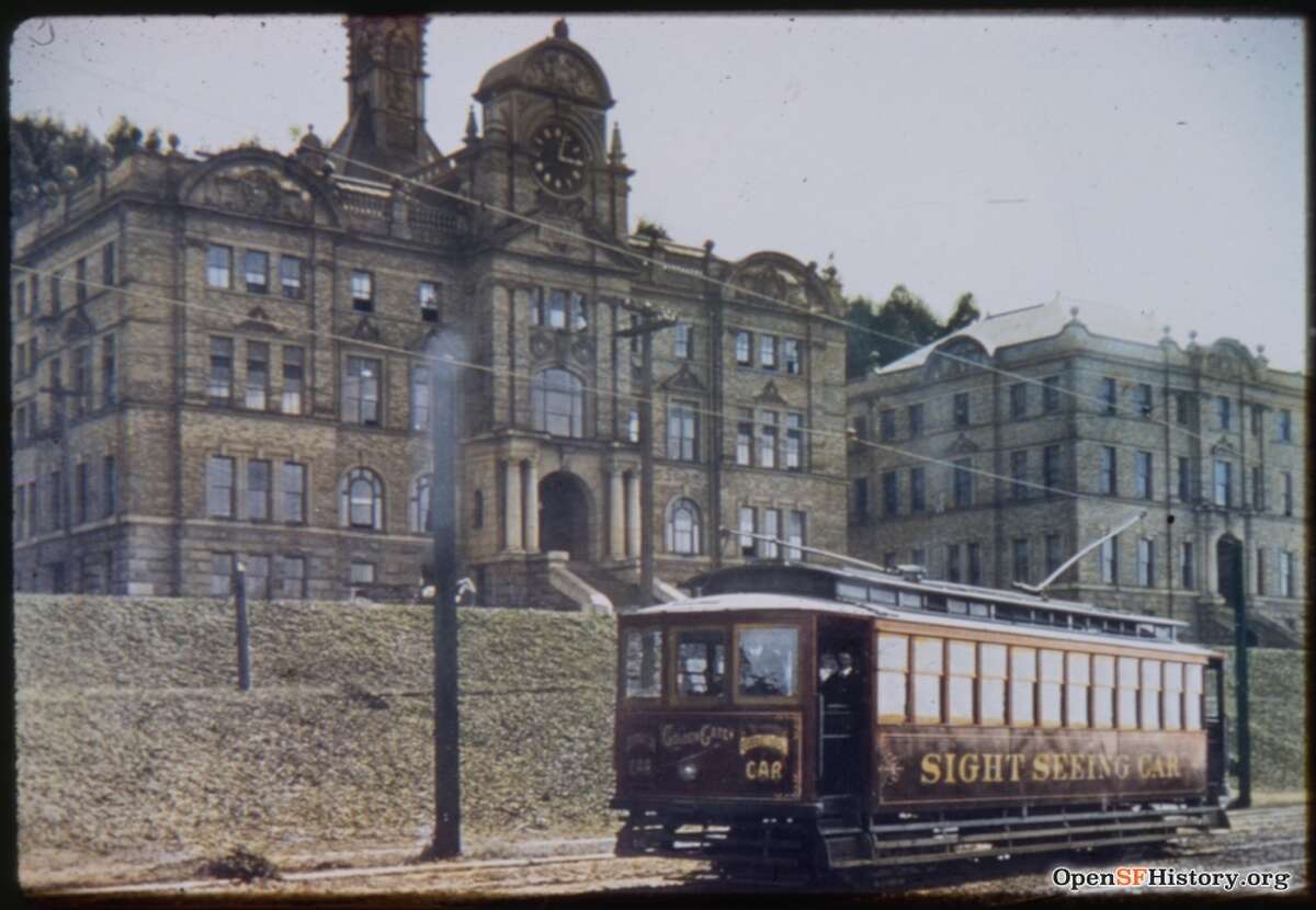 A sightseeing streetcar passes by Parnassus near Second in 1909. The photo was hand-colored by Charles Smallwood.