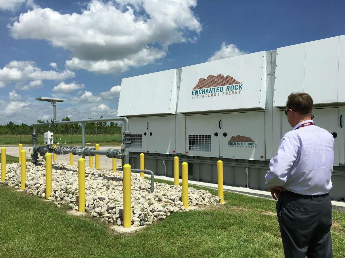 Thomas McAndrew, CEO of Enchanted Rock Energy, stands beside a natural gas generator installed at an HEB Grocery store in Houston, Texas. Enchanted Rock has developed new technology and a new business model that will make emergency generation more affordable for companies like HEB.