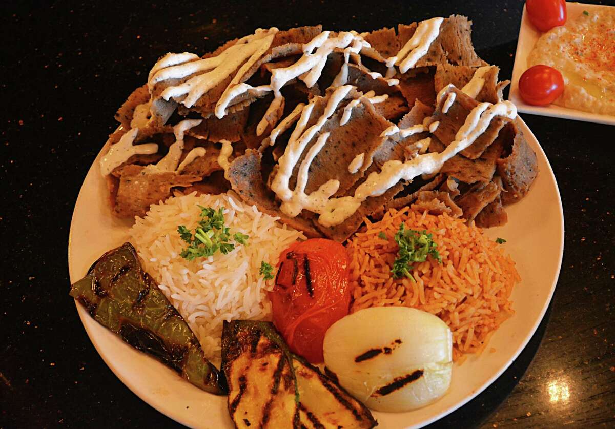 Gyro Love’s gyro platter offers a choice of shaved beef/lamb or chicken topped with tzatziki cucumber sauce, with grilled vegetables, long-grain and brown rices. At far right is the restaurant’s popular hummus dip.