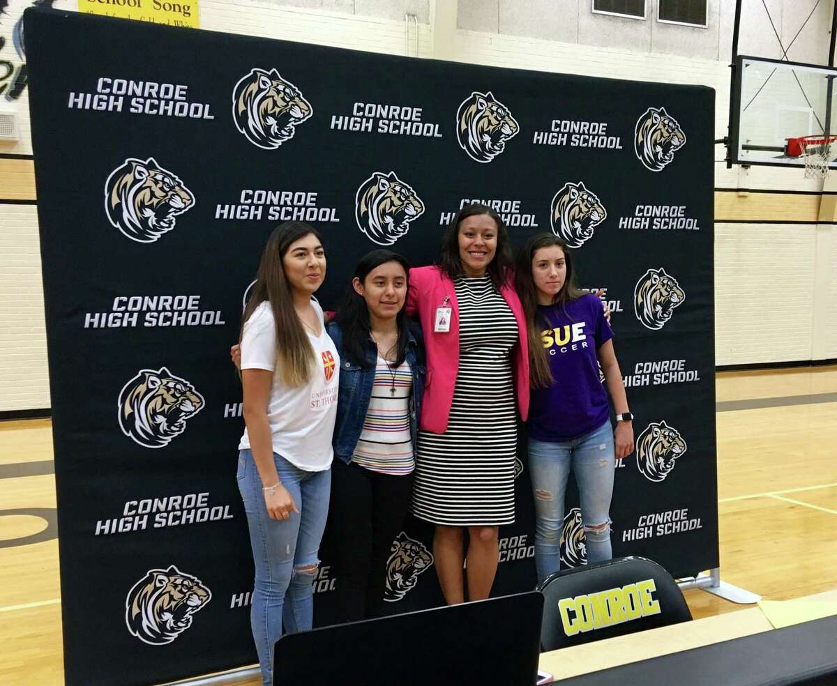 Conroe Lady Tigers soccer's Zarelia Coria, Biririana Hernandez, coach Kesha Cauley and Jazmin Torres pose for photos during National Signing Day on Thursday, April 25, 2019 at Conroe High School.