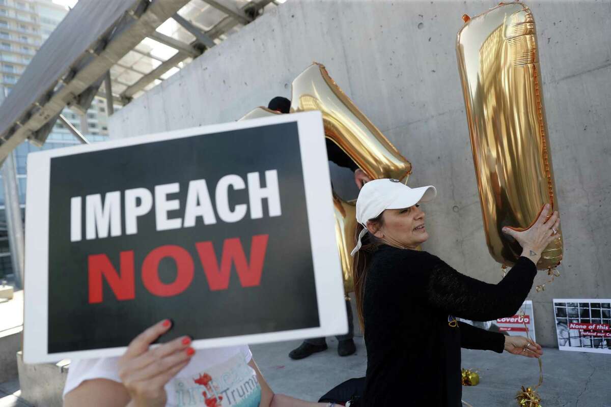 Frankie Wallace assembles a balloon display during an Impeach Donald Trump rally at 7th and Mission Streets outside of House Speaker Nancy Pelosi's office in San Francisco, on Monday. Democrats would be sorely disappointed after impeachment.