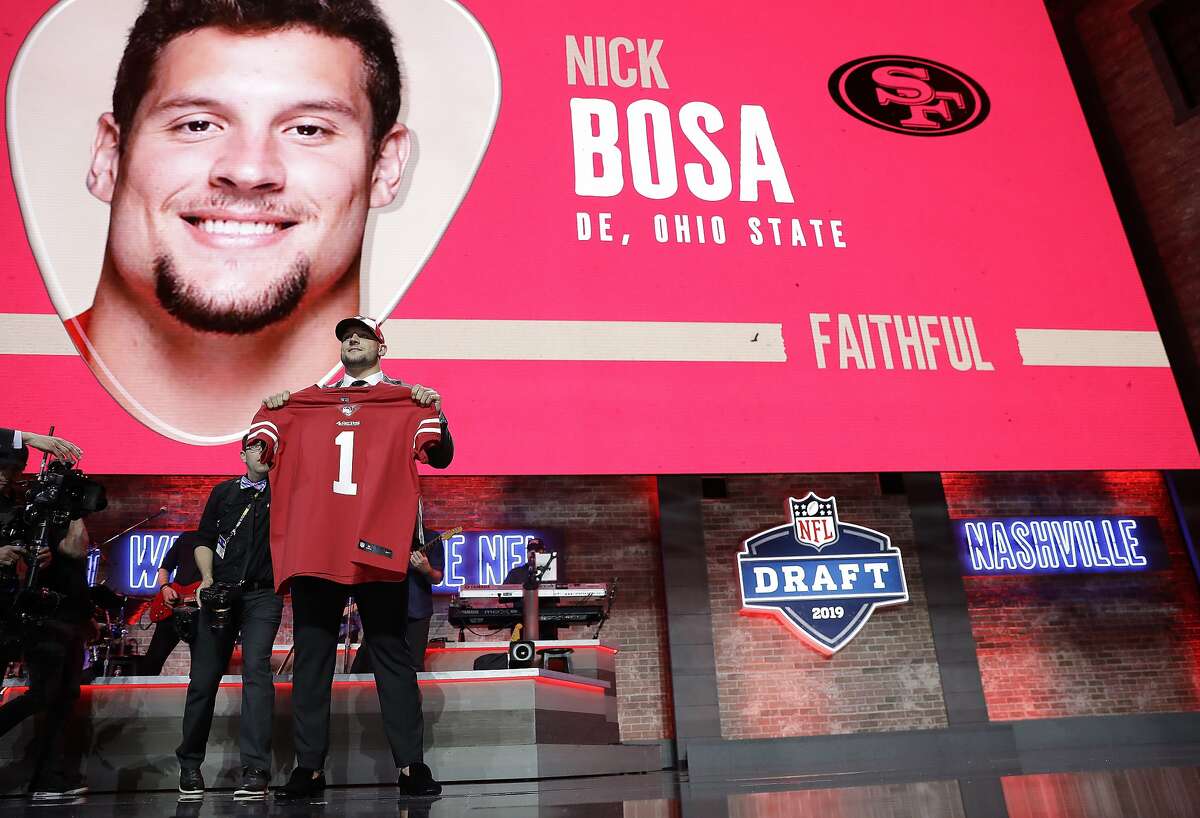 Ohio State defensive end Nick Bosa shows off his new jersey after the San Francisco 49ers selected Bosa in the first round at the NFL football draft, Thursday, April 25, 2019, in Nashville, Tenn. (AP Photo/Mark Humphrey)