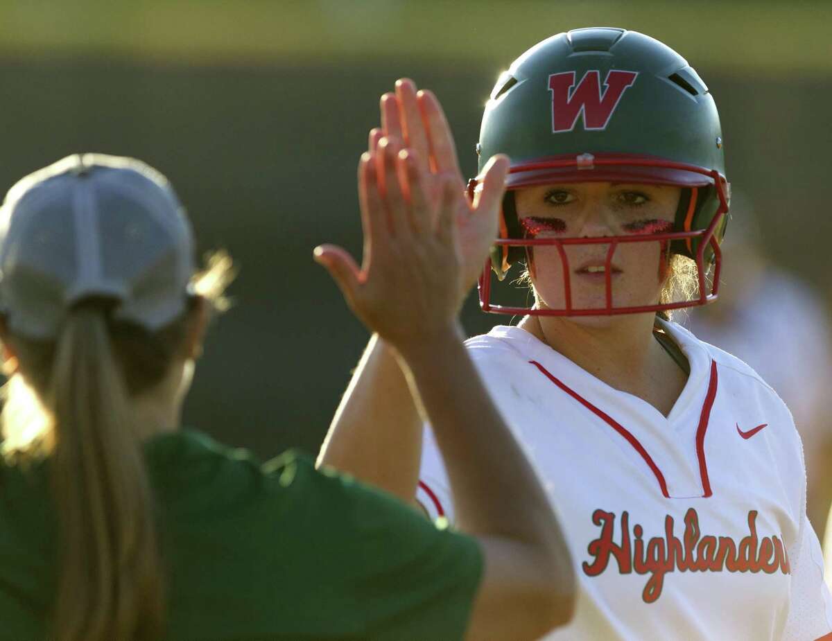 Haley Mountain #29 of The Woodlands gets a high-five from assistant coach Paula Miller after hitting a single in the third inning of Game 2 during a Region II-6A bi-district softball playoff series at Grand Oaks High School, Thursday, April 25, 2019, in Spring.