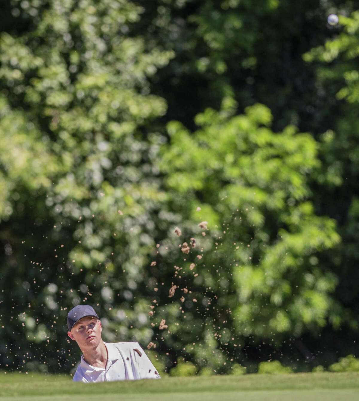 Clark’s Garrett Endicott hits one out of the bunker at No. 12, par 4 during the second round of the Region IV-6A golf tournament at the Republic Golf Club on Thursday, Apr. 25, 2019.