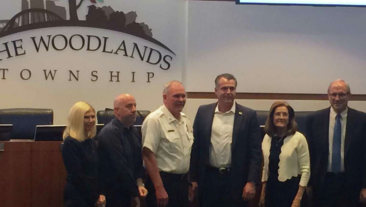 The Woodlands Fire Department Fire Chief Alan Benson, in white, poses with members of The Woodlands Township Board of Directors and township President and General Manager Don Norrell on Wednesday, April 24, after it was announced he was retiring effective May 2, 2019.