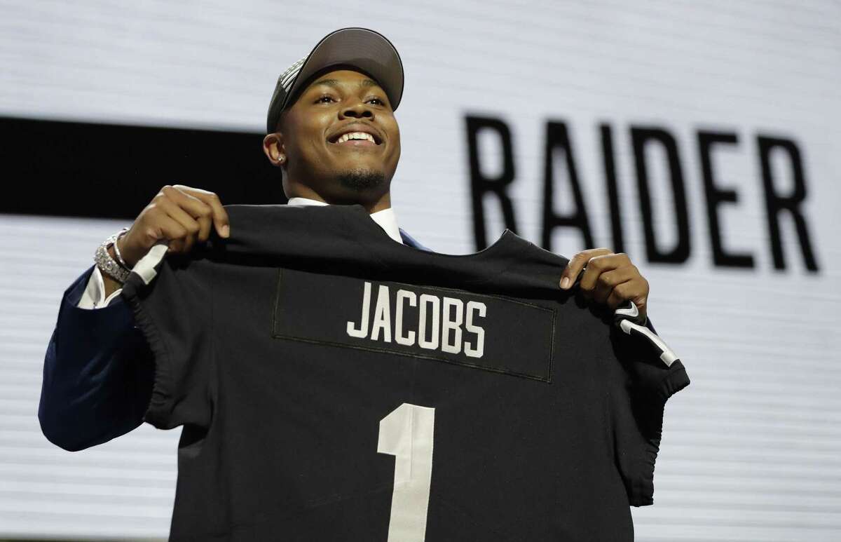 Alabama running back Josh Jacobs poses withhis new jersey after the Oakland Raiders selected Jacobs in the first round at the NFL football draft, Thursday, April 25, 2019, in Nashville, Tenn.(AP Photo/Mark Humphrey)