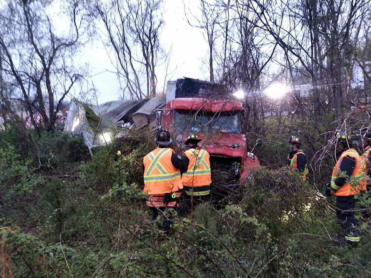 The driver of a tractor-trailer truck escaped injury after the rig went down an embankment off I-95 in Westport on Friday, April 26, 2019. The accident closed the northbound right lane between Exits 18 and 19.