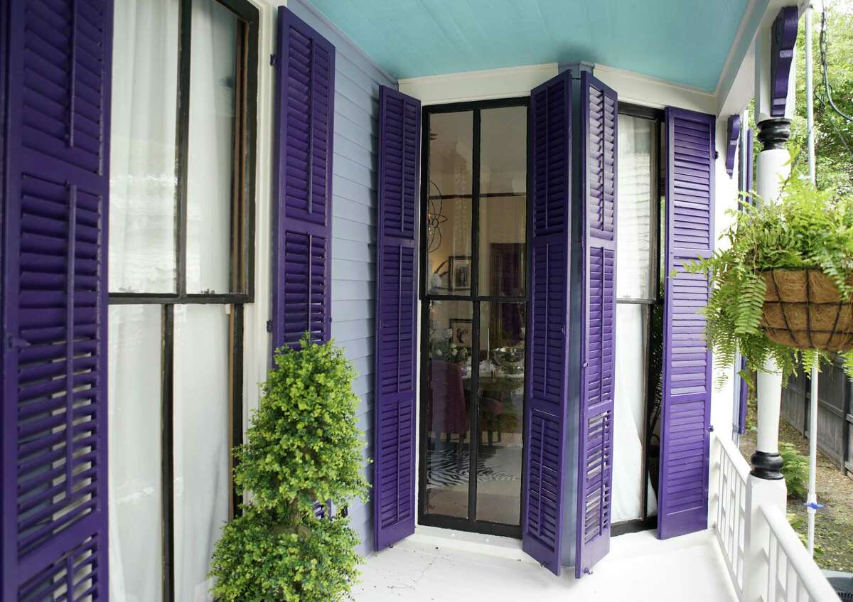 Bold purple paint helps the shutters stand out on the historic Victorian-style home of Frank and Teffeny Caruso in Galveston.