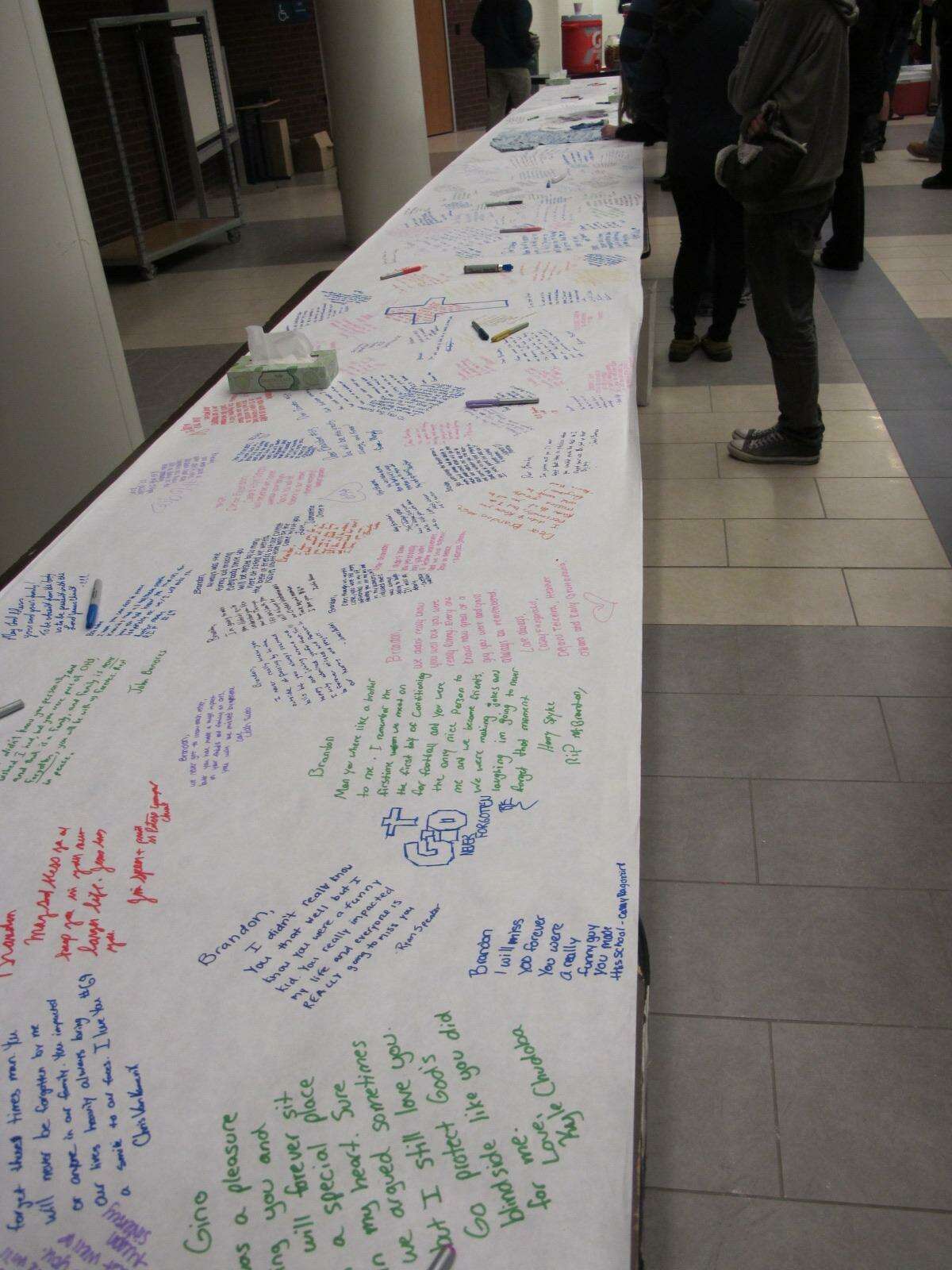 A file photo from March 2012, when hundreds of students, along with parents and teachers, staged an all-day vigil at Oxford High School for Brandon Giordano, who was killed in a crash. In the lobby, students expressed their sorrow by writing on a 36-foot table covered with a long roll of paper.