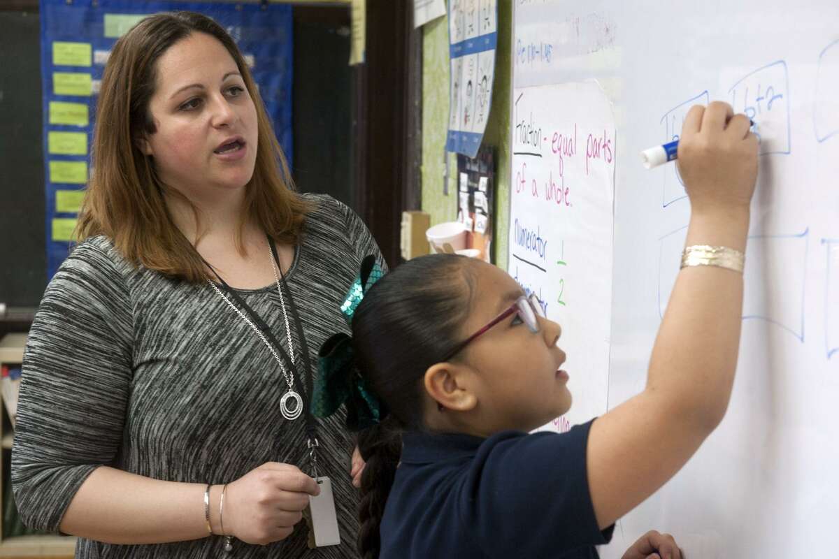 Ashley Lupo works with student Jaleyshia Cruz during a 3rd grade math class at Beardsley School, in Bridgeport, Conn. April 23, 2019. Lupo is one of two Bridgeport teachers to receive this year’s Theodore and Margaret Beard Excellence in Teaching Award.
