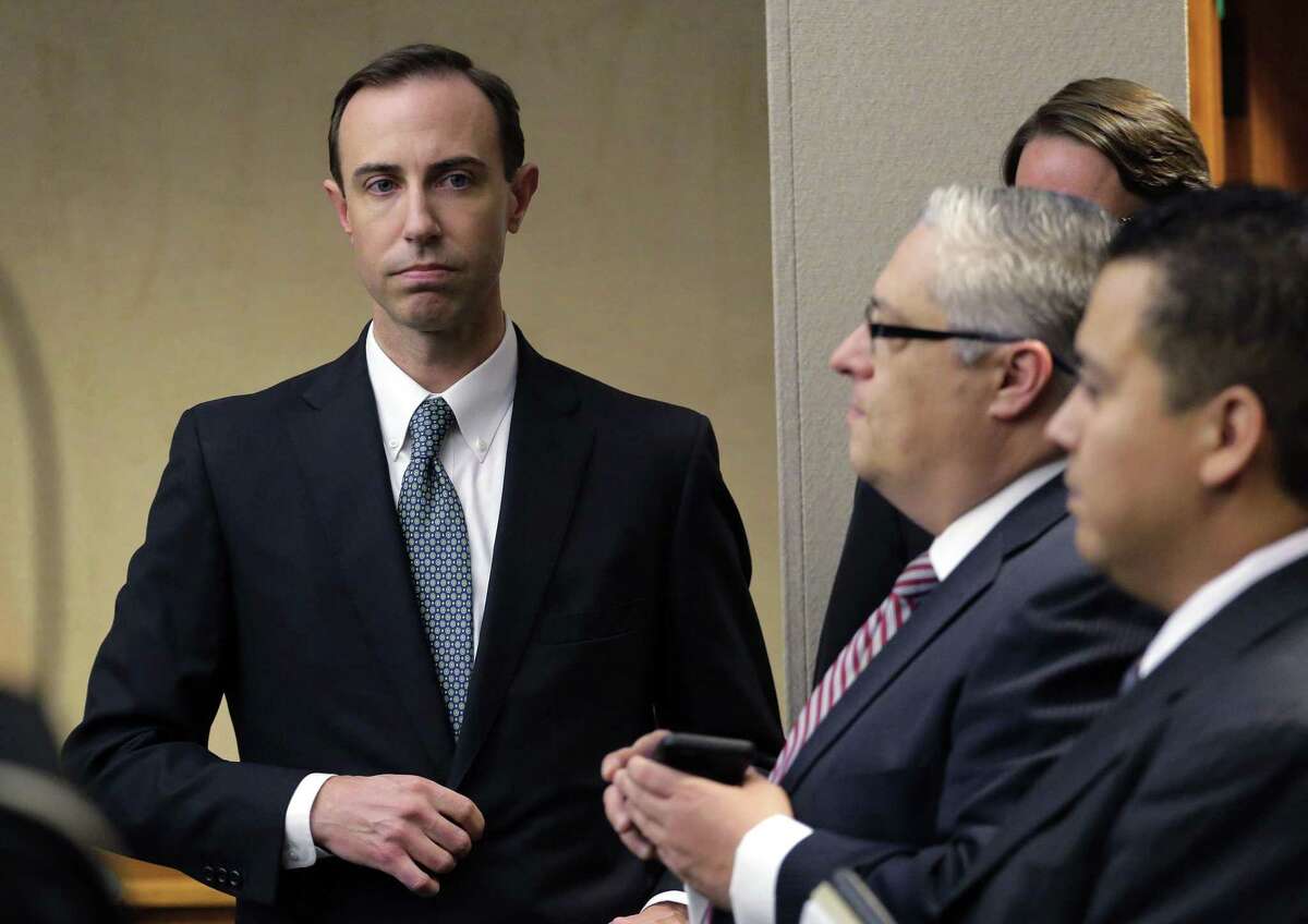 In this Feb. 7, 2019 file photo, Secretary of State David Whitley, left, arrives for his confirmation hearing in Austin, Texas, where he addressed the backlash surrounding Texas' efforts to find noncitizen voters on voter rolls. Whitley’s office released an inaccurate list of 95,000 voters flagged as possible non-U.S. citizens. Friday, his office and the plaintiffs in three lawsuits reached a settlement agreement that will be presented to a federal judge in San Antonio on Monday.