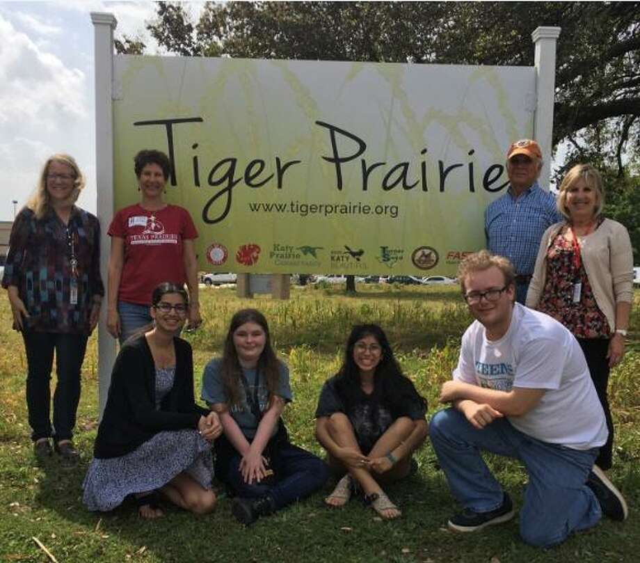 Proud of the new sign for the Tiger Prairie are, from left, standing: Rhonda Burrough, Katy High School environmental teacher; Della Barbato,director of education, Native Prairies Association of Texas; Jim Willis, co-founder/president of Wildlife Habitat Federation; and Susan Barker, Katy High School science instructional coach; in front: students Nandita Deo, Andie Gunn, Brooklyn Garibay and Stone Garza. Photo: Karen Zurawski / Karen Zurawski
