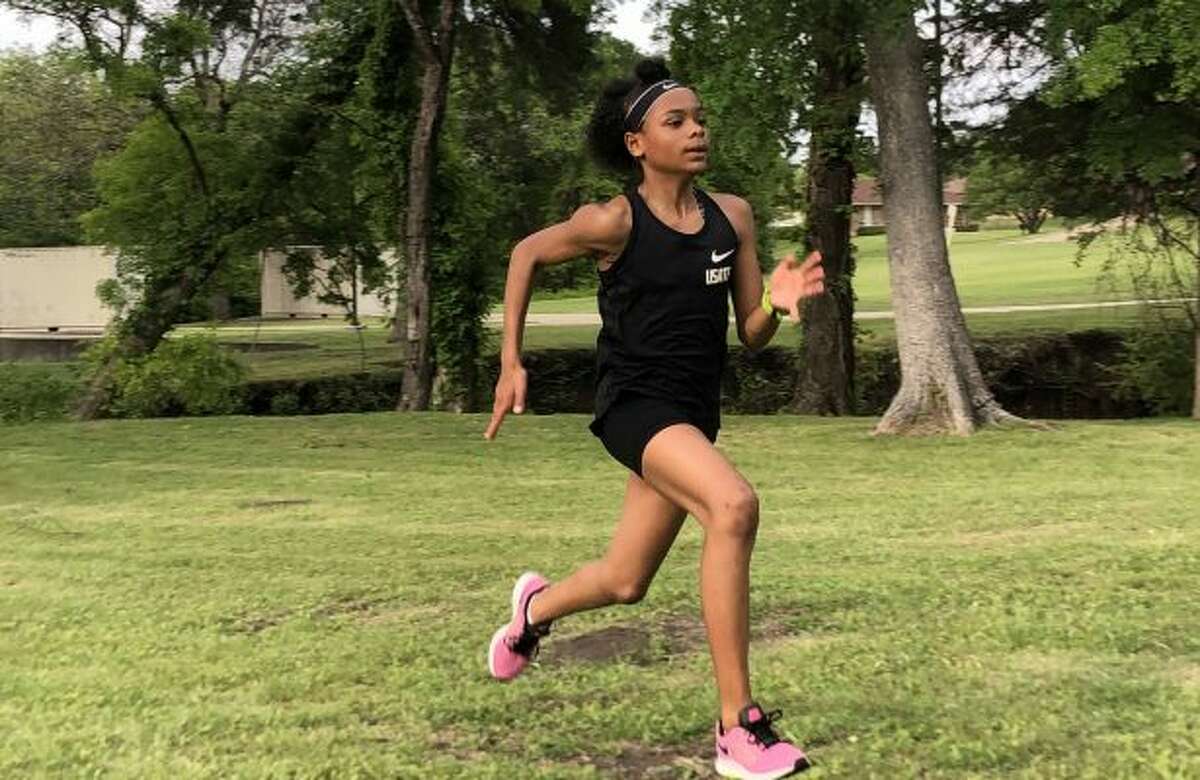 Jordynn working on her running form before the Michael Johnson Invitational at Baylor