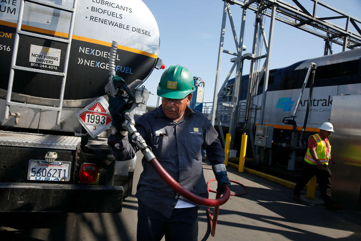 FILE PHOTO : Memo Terrones, Golden Gate Petroleum driver, returns a nozzle to the fuel truck after a Capital Corridor locomotive is filled with renewable diesel at the Amtrak Maintenance Facility on Tuesday, September 12, 2017 in Oakland, Calif. Tightening carbon standards in California are expected to boost demand for renewable diesel and other low carbon fuels. San Antonio's Valero Energy is upgraded its renewable diesel facility New Orleans it owns through a subsidiary called Diamond Alternative Energy.