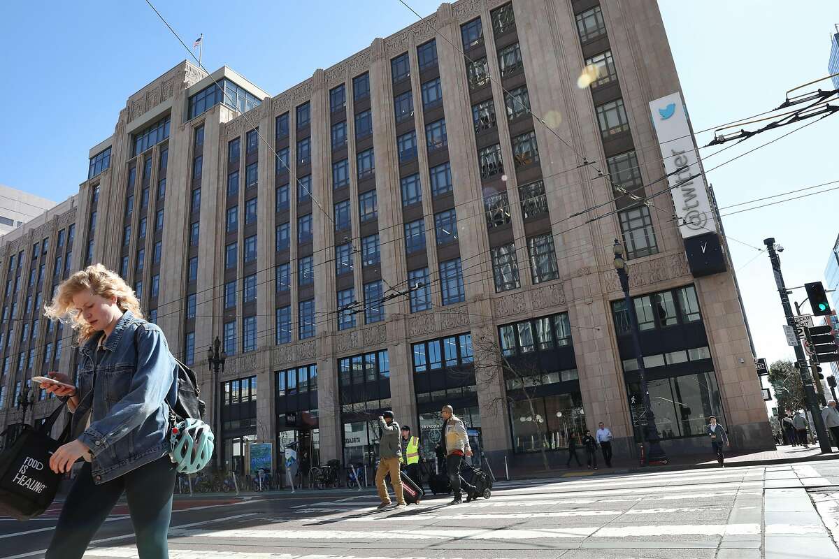 Pedestrians cross Market Street near the Twitter building on Tuesday, March 12, 2019 in San Francisco, Calif.