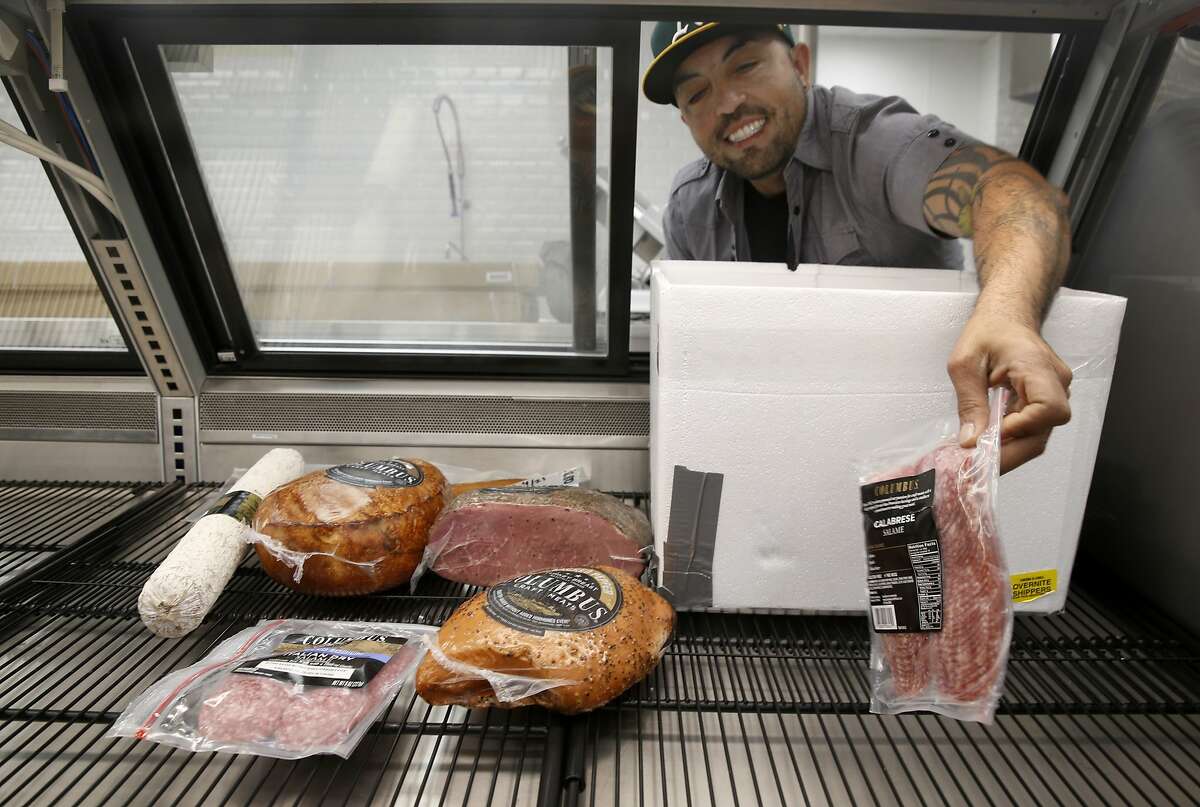 Food service manager Fausto Howay places cured meat in the display case at the new Community Foods Market on San Pablo Avenue in Oakland, Calif. on Friday, April 26, 2019. The new grocery store, which will also serve as a gathering space for the community, will be the first full service market to open in a West Oakland neighborhood long considered to be a food desert.