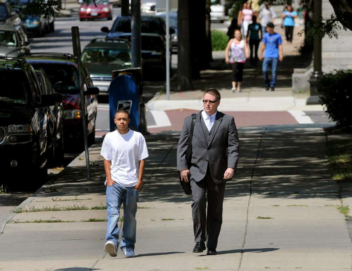 Kemo Santana, 18, and his attorney, Joe Ahearn, head to the Troy Police Department on Tuesday. (Cindy Schultz / Times Union)