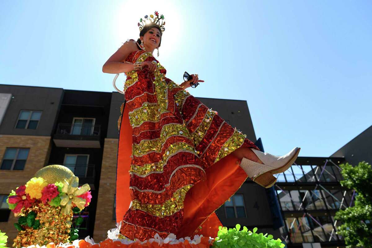 Elizabeth Page Davis, Duchess of Whimsical Artistic Expression, shows her shoe during the Battle of Flowers Parade in 2019.