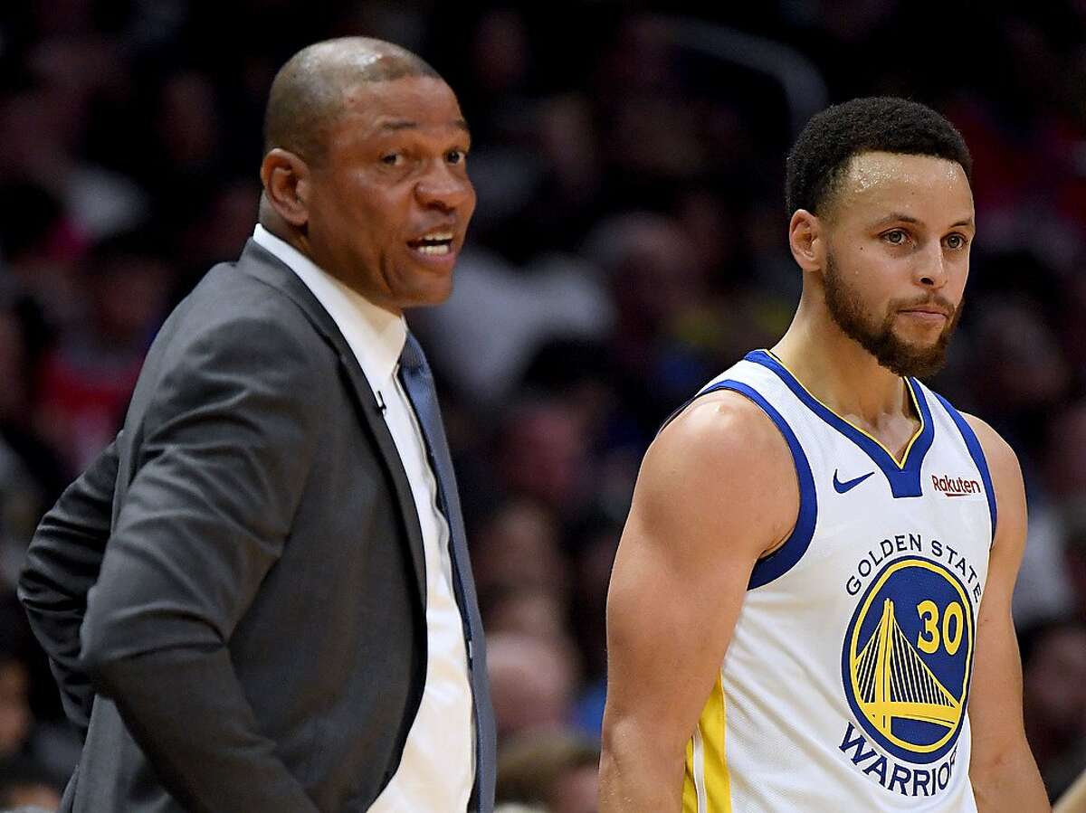 LOS ANGELES, CALIFORNIA - APRIL 21: Stephen Curry #30 of the Golden State Warriors stands next to head coach Doc Rivers of the LA Clippers during the first half in Game Four of Round One of the 2019 NBA Playoffs at Staples Center on April 21, 2019 in Los Angeles, California. (Photo by Harry How/Getty Images) NOTE TO USER: User expressly acknowledges and agrees that, by downloading and or using this photograph, User is consenting to the terms and conditions of the Getty Images License Agreement.