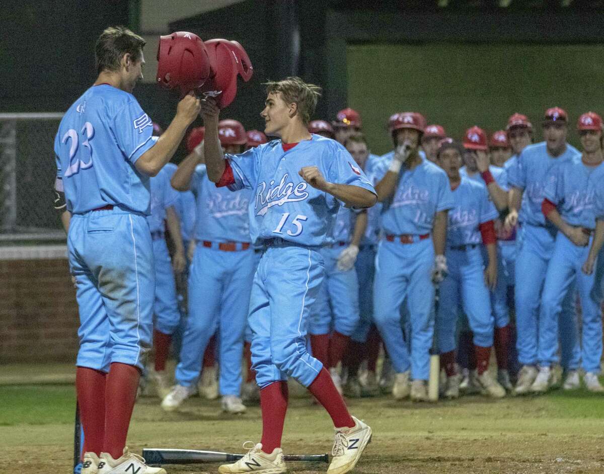 In this file photo, Oak Ridge short stop Carson Ogilvie (15) taps his helmet on Oak Ridge first baseman Kevin Skweres’ (23) after hitting a home run during a District 15-6A baseball game at Oak Ridge High School.